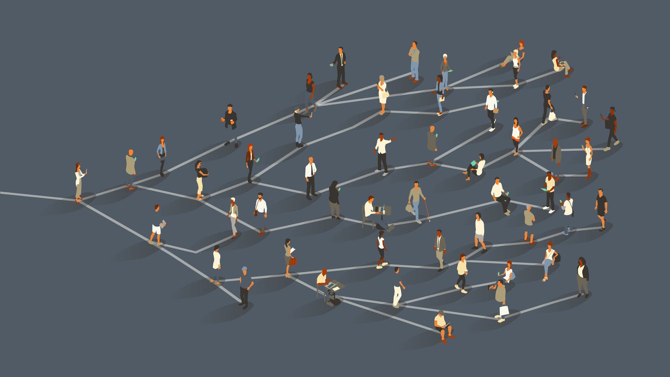 A group of approximately 50 people illustrate the concept of the network effect, or viral growth, as they stand on branch-like lines radiating from a single source. Beginning with one woman, a message or idea branches to two additional people, and so on, ultimately effecting a large crowd. Diverse men and women use digital devices, primarily smartphones. Isometric vector presented in a 16x9 artboard, over a slate gray background.